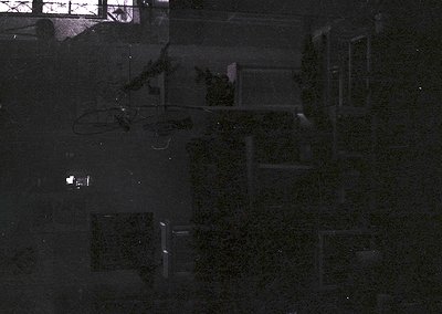 Aerial view of a geometric, grid-patterned courtyard with manicured shrubs forming rectangular shapes. Likely a public or ins...