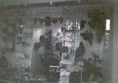 Aerial black-and-white photo of a densely built urban area with grid-like streets and clustered buildings, likely from the mi...