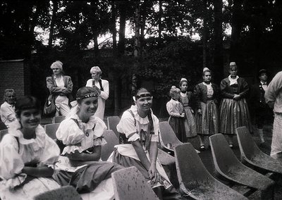 Vintage black-and-white group photo featuring women in traditional folk attire, likely Eastern European, with embroidered blo...
