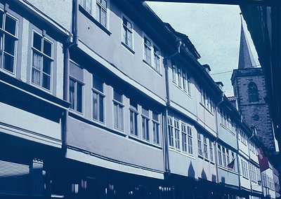 Timeless European street scene featuring half-timbered buildings with white-framed windows, likely 19th-century architecture....