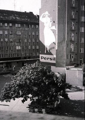 Vintage 1960s-70s urban billboard featuring a stylized white silhouette of a woman in a flowing dress, advertising **Persil**...