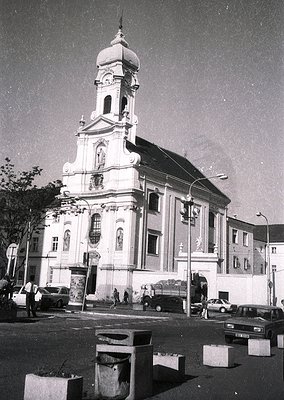 Neoclassical church with domed bell tower and decorative facade, likely mid-20th century. Prominent arched windows and sculpt...