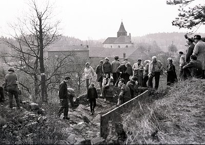 Community labor effort in rural Europe, mid-20th century. Group of men, women, and children manually clearing rocky terrain w...