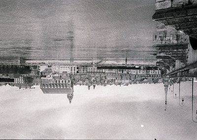 Aerial black-and-white photograph of a coastal cityscape, likely from the early-to-mid 20th century. Symmetrical row of unifo...