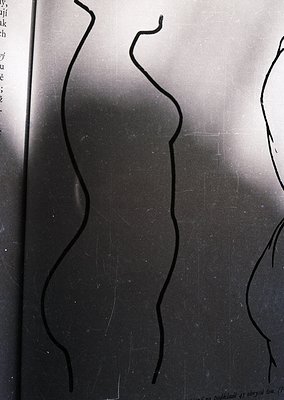 Silhouetted black line art of two human figures in dynamic, flowing poses on a textured surface, likely a vintage map or atla...