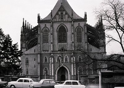 Gothic Revival church facade with pointed arches, spires, and intricate stonework, likely mid-20th century. Symmetrical desig...