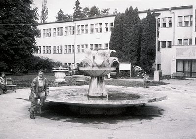 Mid-20th century courtyard with Soviet-era institutional building featuring symmetrical windows and concrete design. Central ...