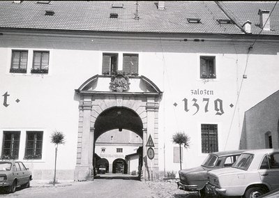 Historic stone archway entrance with "Zaloz̆en 1379" inscribed, indicating 1379 foundation. Classic European architectural de...
