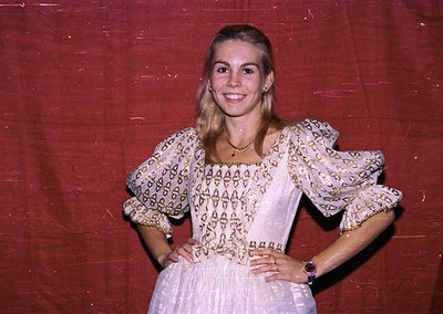 Vintage portrait of a woman in a traditional embroidered blouse with puffed sleeves, paired with a flowing skirt. The pattern...