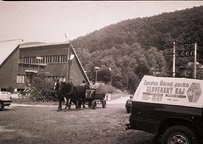 Horse-drawn cart alongside a truck labeled "Slovenský raj" (Slovak Paradise) in a rural setting, likely Slovakia. Mid-20th ce...