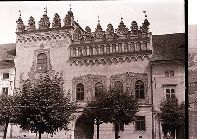 Historic Baroque-style building with ornate stonework, featuring intricate carvings, arched windows, and decorative spires. L...