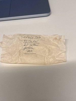 Handwritten note on aged paper: "25 гр. ТОП Въщо дневи 25 ст. полски лева." Partial laptop in background. Likely Bulgarian cu...