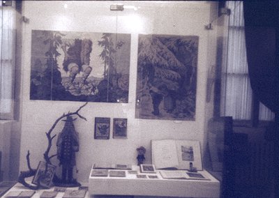 Vintage exhibition display featuring two large monochrome prints of forest scenes with human figures, likely from the 1960s–7...