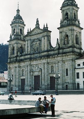 Baroque-style cathedral with twin bell towers, intricate stone carvings, and a central pediment. Foreground shows mid-20th ce...