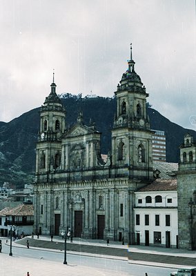 Baroque-style cathedral with twin bell towers and intricate stonework, set against mountainous backdrop. Likely á’s Basilica ...