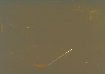 Vintage sepia-toned photograph of a **fishing rod and reel** partially submerged in murky water, likely a lake or river. The ...