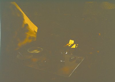 Vintage close-up of a retro electric stove with two burners, one lit with a yellow flame. The design suggests mid-20th centur...