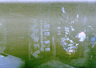 Vintage aerial view of a densely built urban area with grid-like streets and low-rise buildings, likely from the 1950s–1970s....