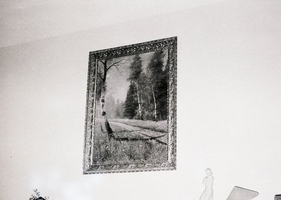 Vintage framed landscape print depicting dense forest with a fallen tree trunk in foreground. Ornate gilded frame suggests mi...