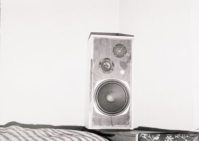 Vintage wooden speaker with dual circular knobs and single large woofer, likely mid-20th century. Clean lines and minimalist ...
