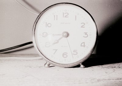 Vintage analog alarm clock with "Sevani" branding, showing 10:10. Minimalist design with three metal legs on a flat surface, ...