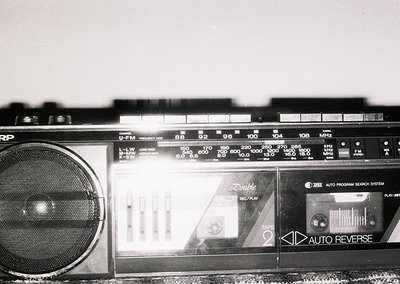 Vintage double-cassette boombox with "Double" and "Auto Reverse" labels, featuring analog tuning dials and a graphic equalize...