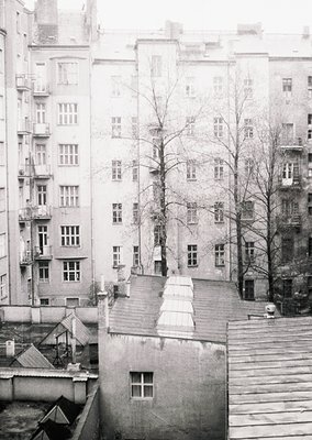 Mid-century Soviet-era apartment block with symmetrical, utilitarian design—symmetrical windows, flat roofs, and narrow balco...