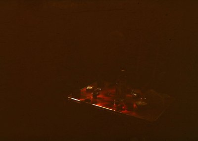 Vintage military tank silhouette against low-light backdrop, likely mid-20th century. Blurred details suggest motion or low-r...