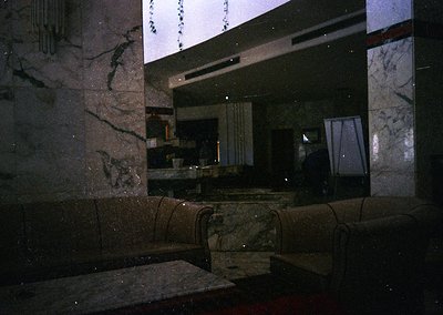 Marble-clad interior with geometric precision, featuring sleek countertops and built-in seating. Reflective surfaces capture ...