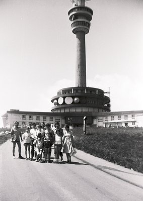 Iconic 1960s Soviet-era observation tower with Brutalist design, likely the *Teleferik Tower* in Varna, Bulgaria. Group of pe...