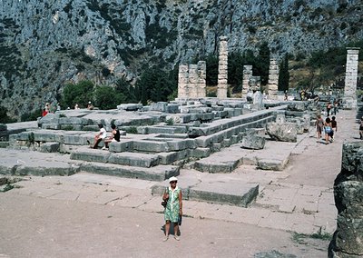 Ancient Hellenistic ruins featuring Doric columns and stone platforms in a mountainous setting. Likely the Temple of Dionysus...