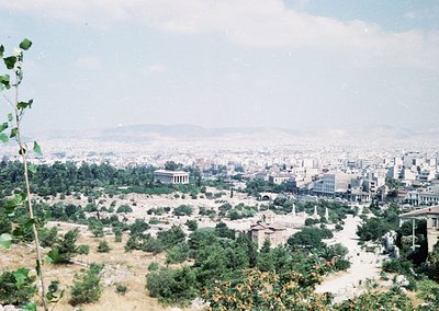 Vintage aerial view of Athens’ ancient ruins blending with modern urban sprawl. The Parthenon and surrounding classical struc...