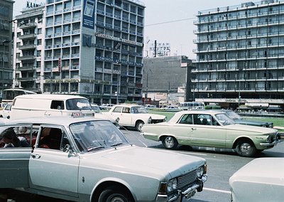 Vintage urban scene featuring mid-rise Soviet-era concrete apartment blocks with Cyrillic signage (). Foreground showcases 19...