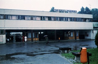 Mid-century institutional building with brutalist concrete elements, featuring a sign reading *"ТЕХНИКУМ МЕХАНИЗАЦИЯ СЕЛСКОТО...