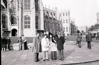Black-and-white photo of Buckingham Palace exterior, mid-20th century. Gothic Revival architecture with pointed arches and or...