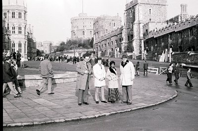 Black-and-white street scene at **Varna’s 1960s seaside fortress**, featuring medieval-style towers and fortified walls. Grou...