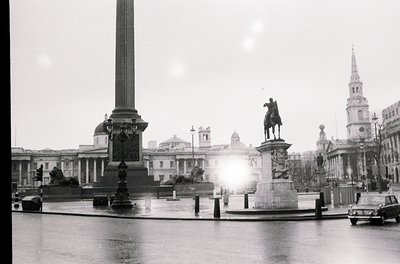 Classic black-and-white shot of Trafalgar Square’s Nelson’s Column (1840s) and equestrian statue (Charles I, 1633) in London,...