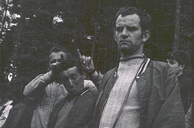 Vintage black-and-white portrait of two men in formal attire, likely from the early-to-mid 20th century. The man in focus wea...