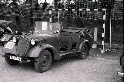 Vintage open-top convertible car, likely a 1930s–1940s European model, parked on gravel with visible license plate "PY-07-74....
