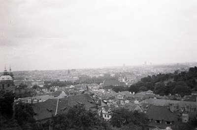 Vintage black-and-white aerial view of a European cityscape, likely early-to-mid 20th century. Dense cluster of low-rise buil...