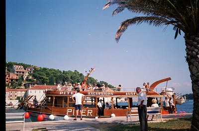 Vintage wooden excursion boat named **"Piter"** docked at a seaside port, labeled "Excursions" in bold letters. Mid-20th cent...