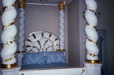 Elaborate synagogue interior featuring ornate **Ark (Aron Kodesh)** with gold-accented white marble columns and a scalloped s...