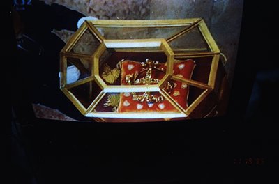 Vintage ornate jewelry display case with hexagonal gold frame, showcasing a red velvet-lined interior holding intricate gold ...