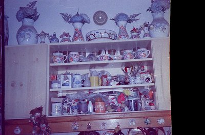Vintage wooden shelf displaying handcrafted ceramic and glassware, likely Eastern European folk art from the 1960s–70s. Decor...