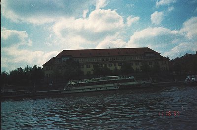 Large, multi-story building with flat roof and symmetrical windows, likely institutional or public architecture, positioned a...