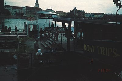 Vintage boat dock with "BOAT TRIPS" signage, likely Stockholm’s Gamla Stan district. Classic 1970s color sepia tone captures ...