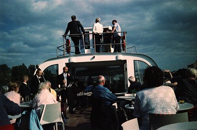 Vintage floating restaurant or observation deck with mid-century modern design, featuring a curved, white exterior and open-a...