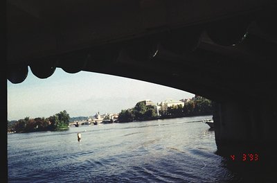 Vintage shot of a river scene framed by a boat’s windshield. Historic European cityscape with domed church and classical arch...