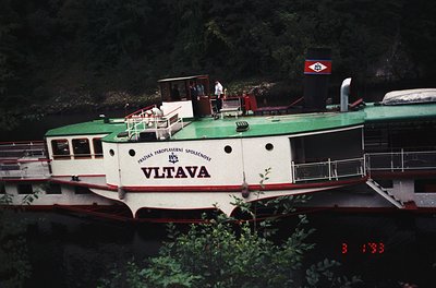 Vintage riverboat "Vltava" with green and white livery, reflecting mid-20th century Czech design. Prominent "Praha" (Prague) ...