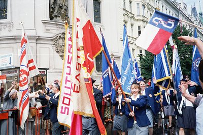 Group of marchers in 1970s-era Southeastern U.S. holding flags for "Southeastern" and "United Blue" with "Southern" text, lik...